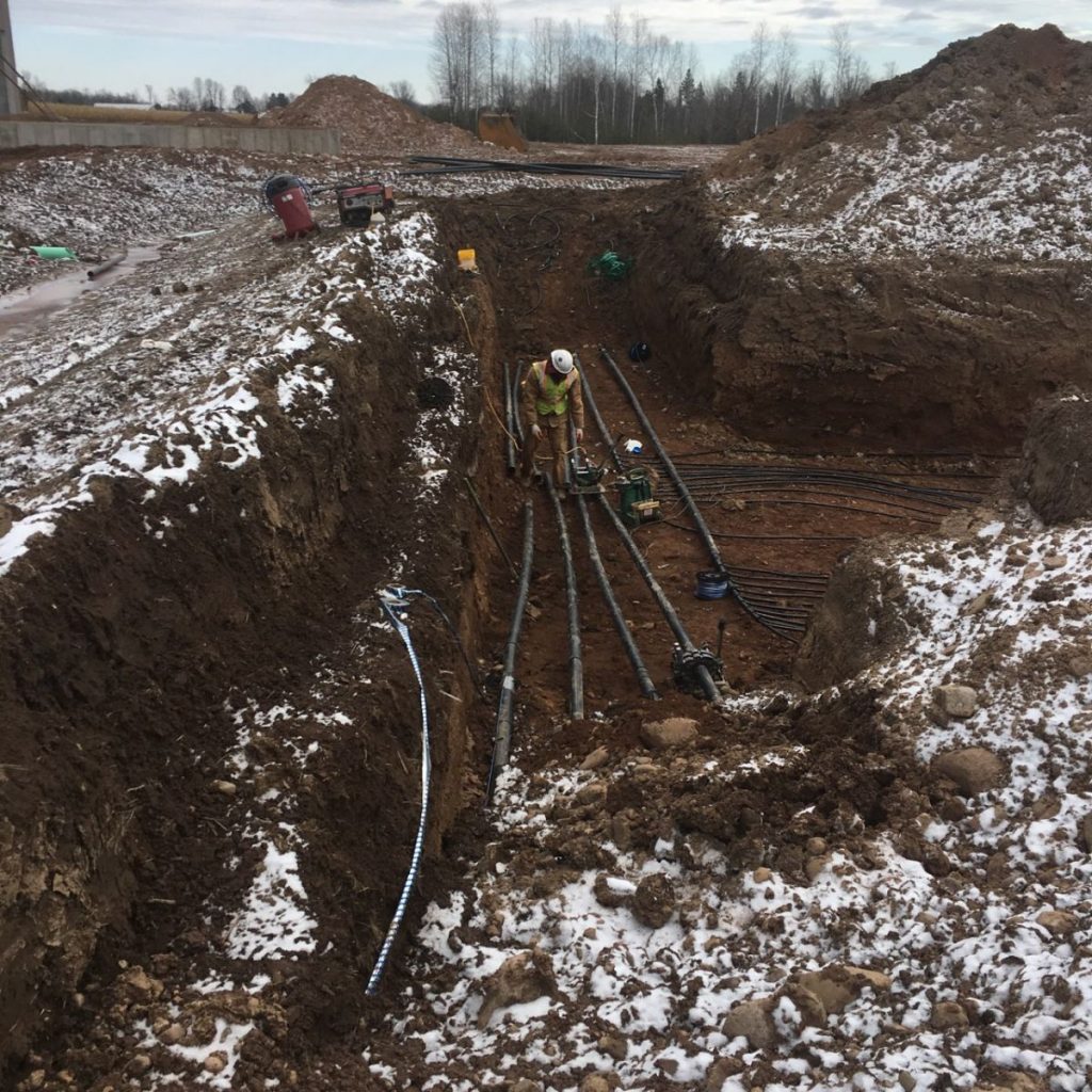 Pipes being layed underground in the winter